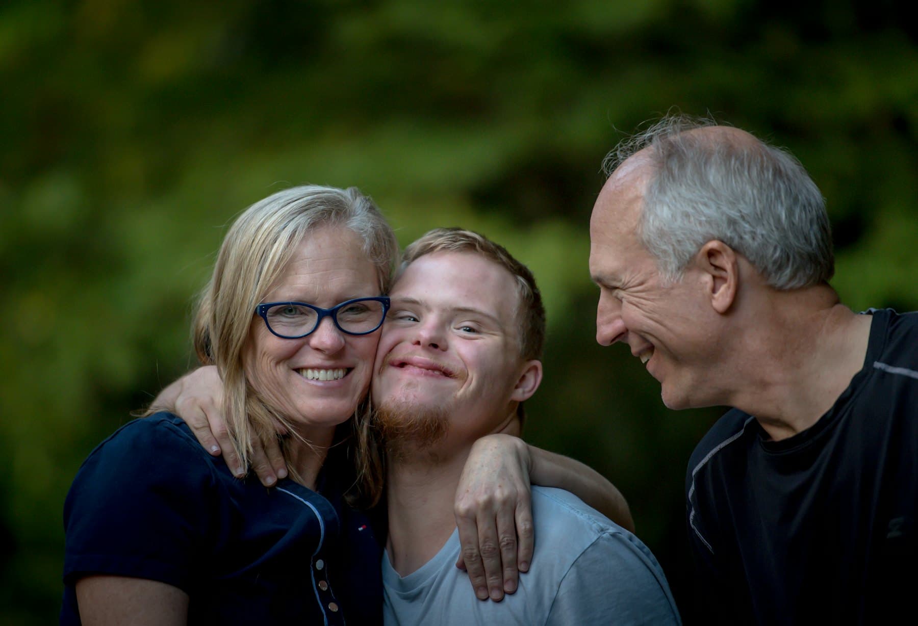 A young man with family members smiling together